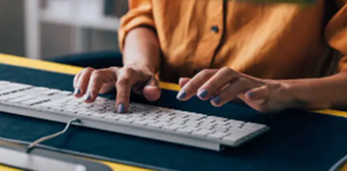 Women typing on a computer keyboard