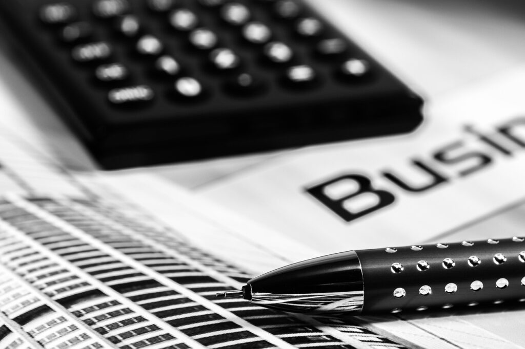 A pen and calculator on a desk