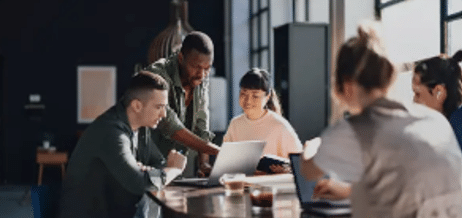 Collaborazione di squadra in uno spazio di lavoro moderno con computer portatili e discussioni