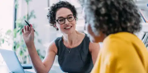 Two colleagues discussing professional solutions