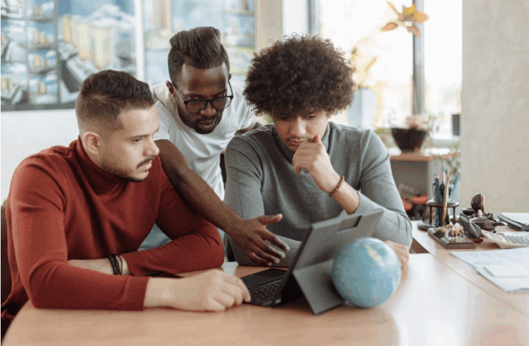 A man showing something to his colleagueson a tablet