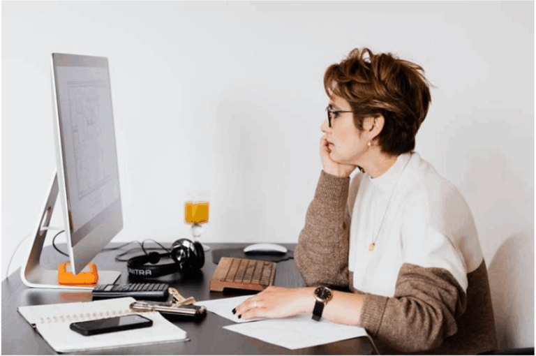 A woman showing something on a screen