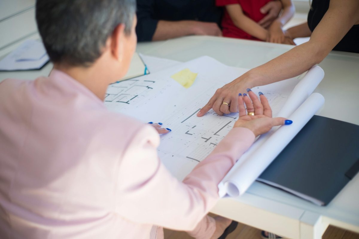 Business consultants reviewing project costs and client profitability metrics