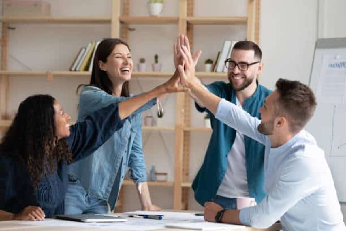 A group of colleagues doing a high-five
