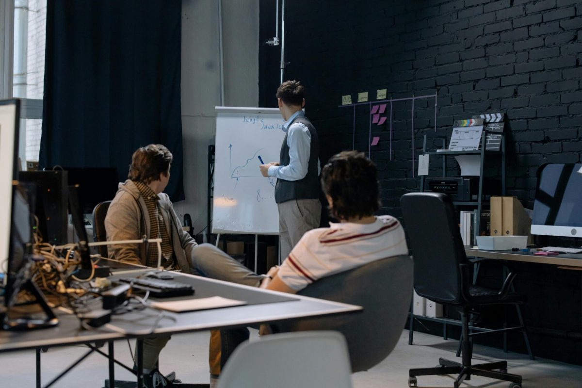 Meeting in an office with a whitboard to write on