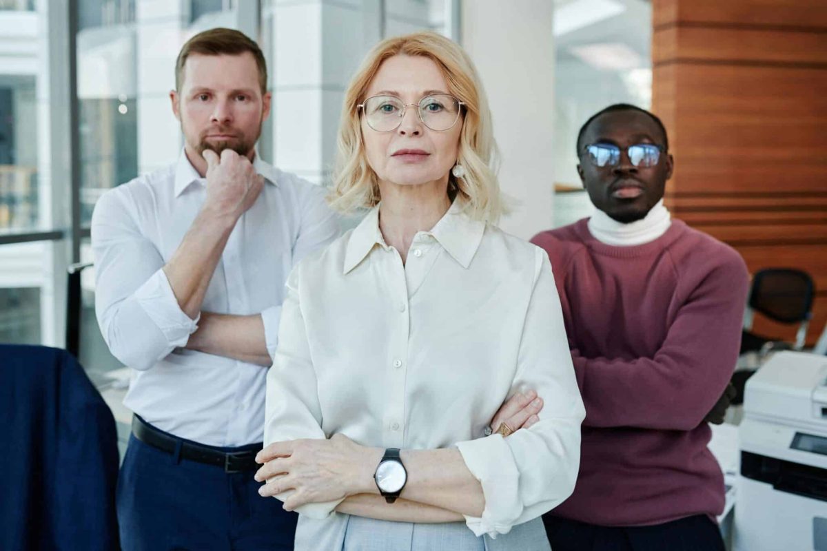 Two colleagues standing with arms crossed