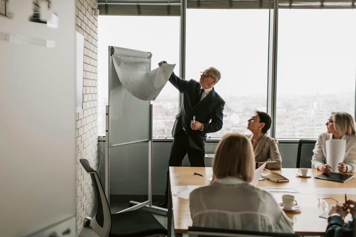 A group of people looking at a board