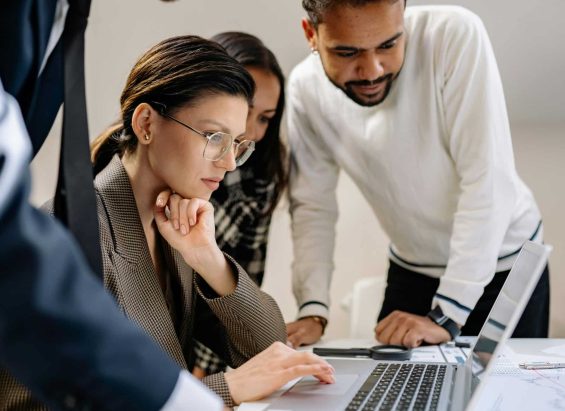 Team members focused on a screen