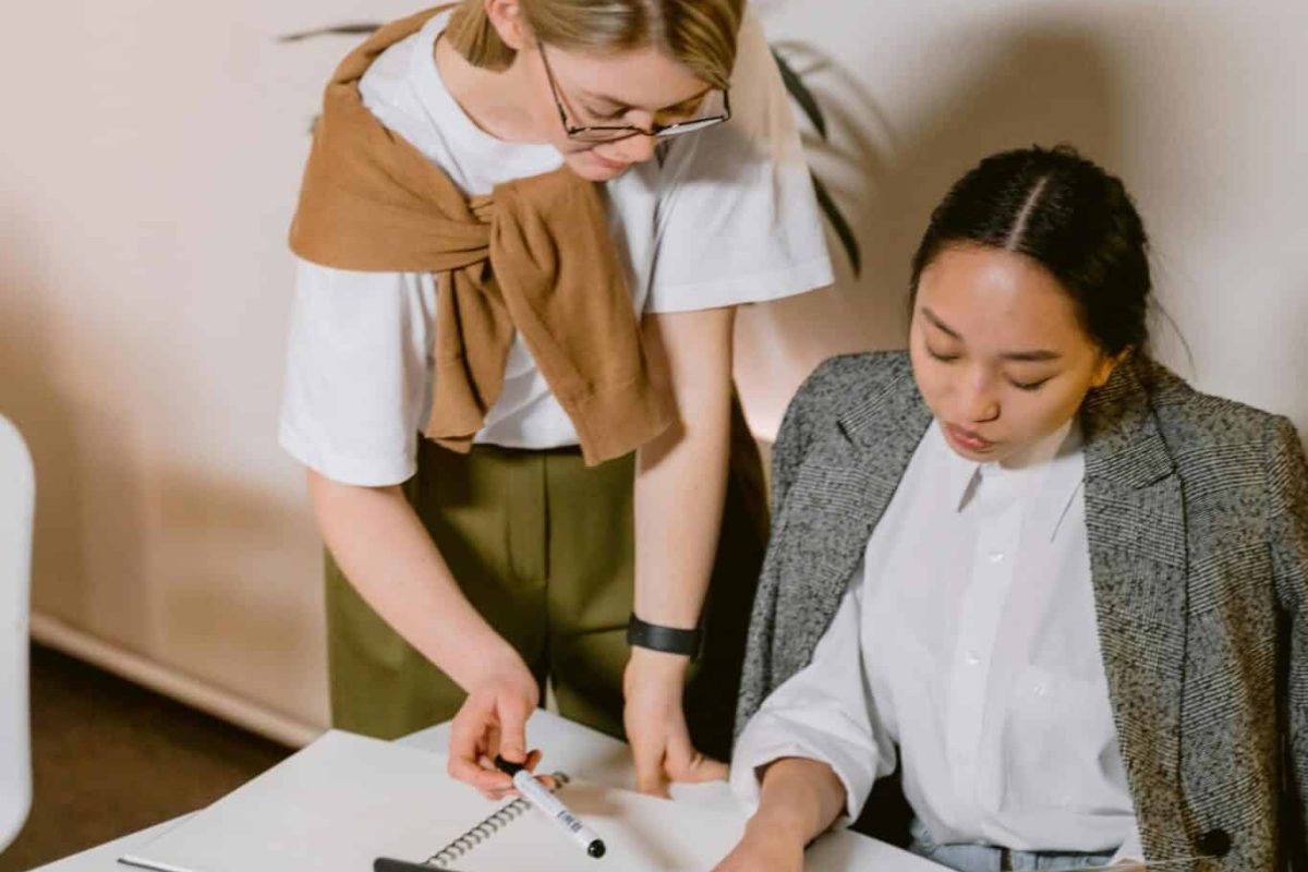 A woman showing a document to her colleague