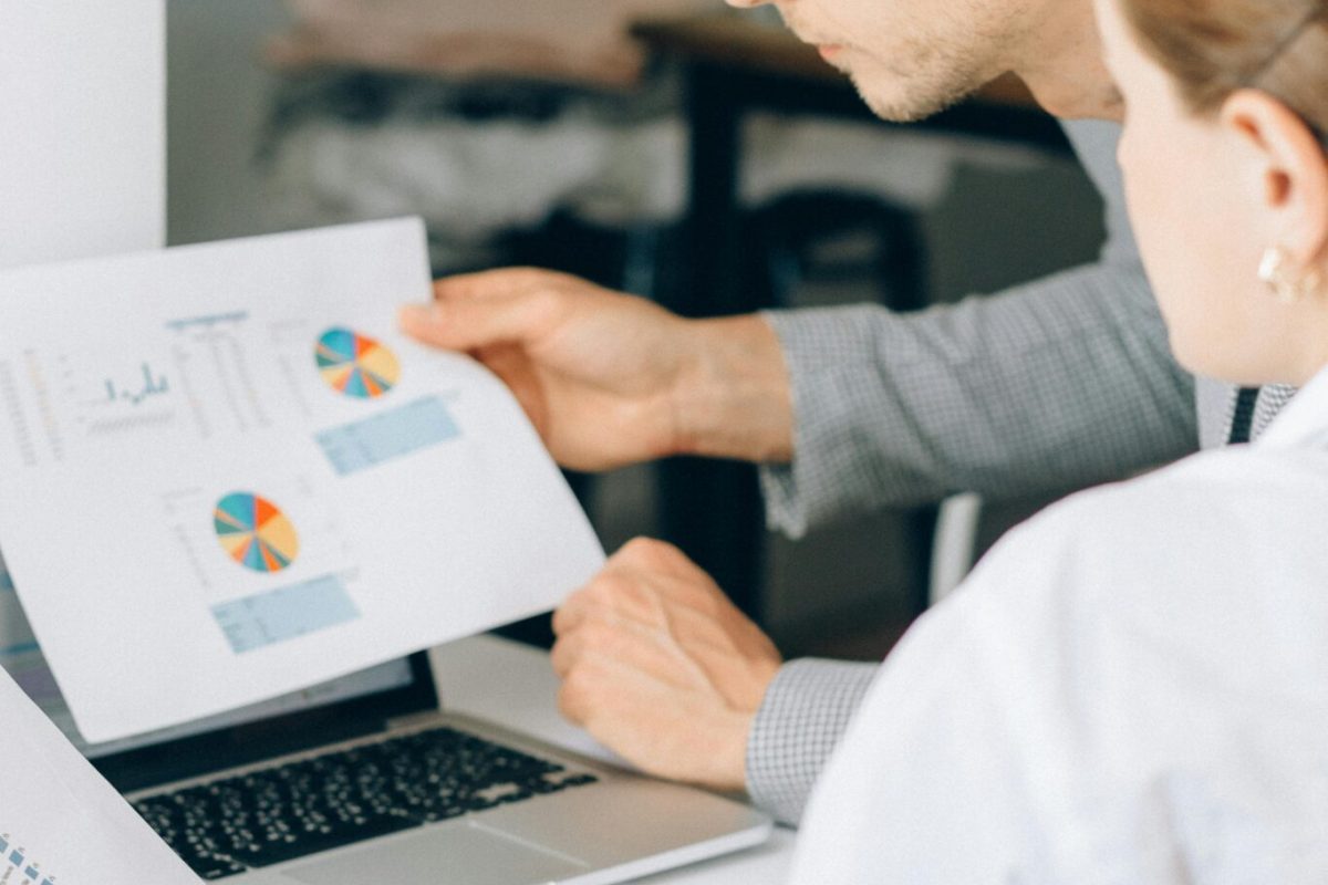 Two professionals analyzing project charts